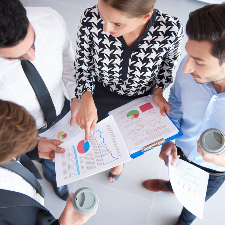 Four businessmen analyzing some documents